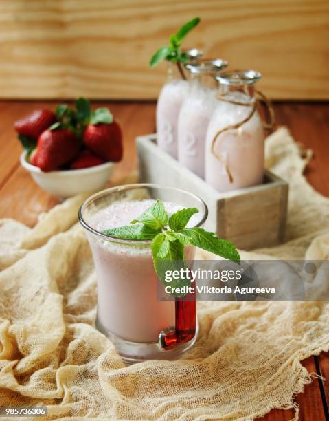 strawberry milkshake on a rustic wooden table - strawberry milkshake and nobody stock pictures, royalty-free photos & images