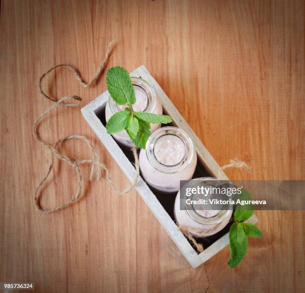 strawberry milkshake on a rustic wooden table - strawberry milkshake and nobody stock pictures, royalty-free photos & images