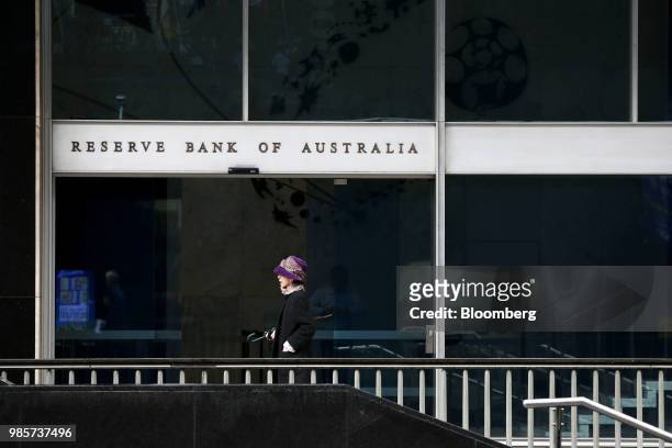 Pedestrian walks past the Reserve Bank of Australia headquarters in the central business district of Sydney, Australia, on Thursday, June 21, 2018....