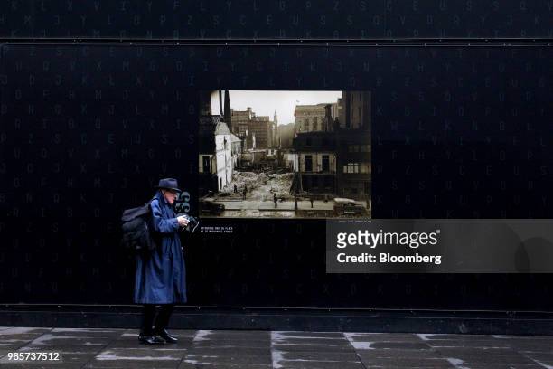 Pedestrian walks past a construction hoarding in Martin Place in the central business district of Sydney, Australia, on Monday, June 18, 2018....