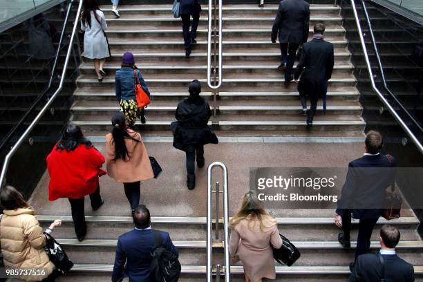 Commuters walk up a flight of stairs at Martin Place in the central business district of Sydney, Australia, on Monday, June 18, 2018. Australia is...