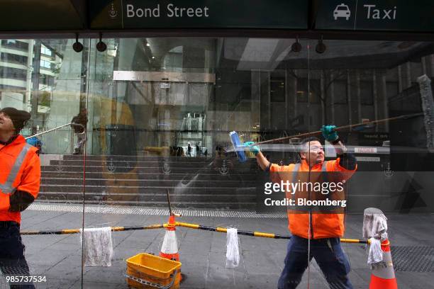 Workers clean windows at a taxi rank in the central business district of Sydney, Australia, on Monday, June 18, 2018. Australia is riding out a huge...