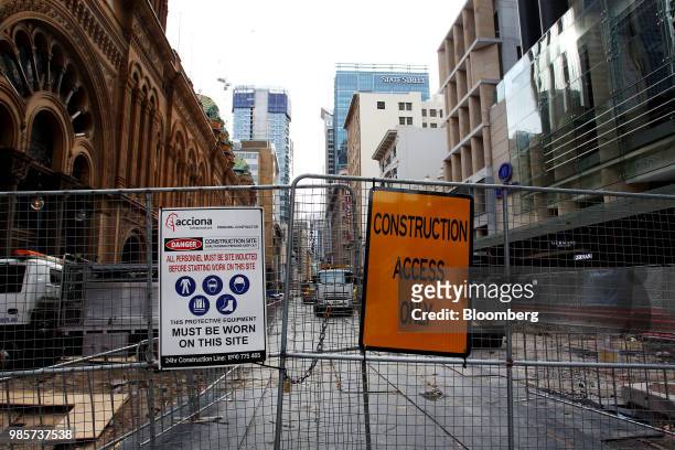 Warning sign is displayed on a fence at a construction site on George Street in the central business district of Sydney, Australia, on Monday, June...