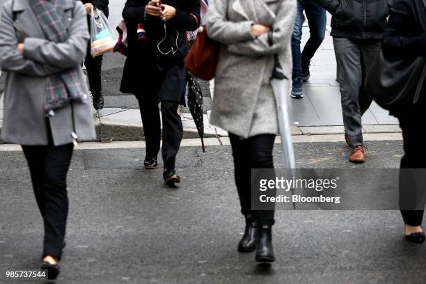 Commuters walk along Martin Place in the central business district of Sydney, Australia, on Thursday, June 21, 2018. Australia is riding out a huge...