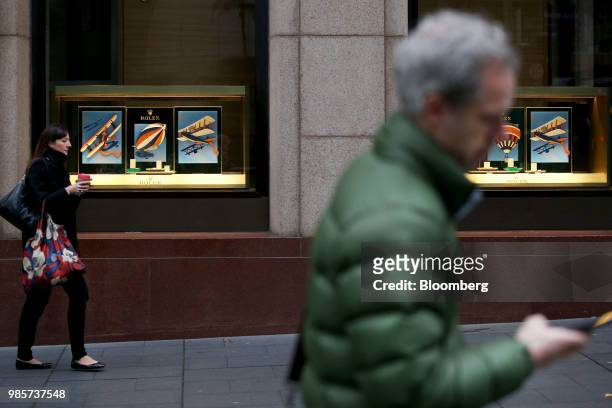 Pedestrians walk past a Rolex Group store at Martin Place in the central business district of Sydney, Australia, on Monday, June 18, 2018. Australia...