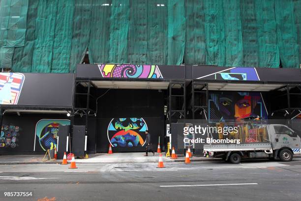 Pedestrian walks past a construction site in the central business district of Sydney, Australia, on Monday, June 18, 2018. Australia is riding out a...