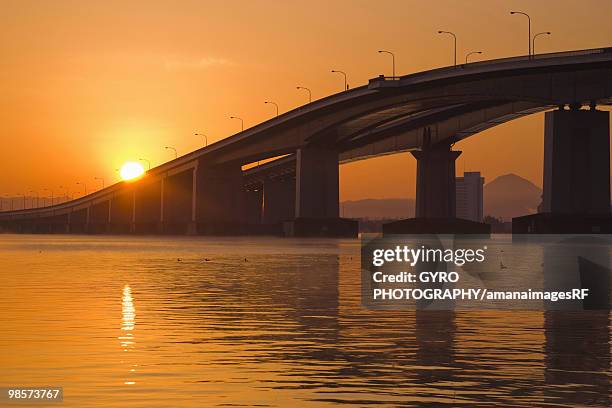 bridge over lake biwa at sunset, otsu, shiga prefecture, japan - otsu imagens e fotografias de stock