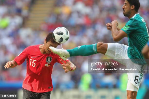 Sami Khedira of Germany is challenged by Wooyoung Jung of Korea Republic during the 2018 FIFA World Cup Russia group F match between Korea Republic...