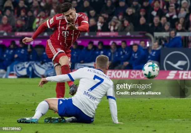 Bayern Munich's Robert Lewandowski and Schalke's Max Meyer fight for the ball at the Allianz Arena in Munich, Germany, 10 February 2018. Photo: Sven...