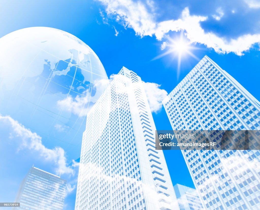 Globe over skyscrapers