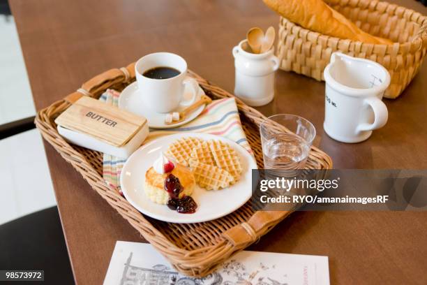 waffles with blueberry sauce and whipped cream - fruit sauce stock pictures, royalty-free photos & images