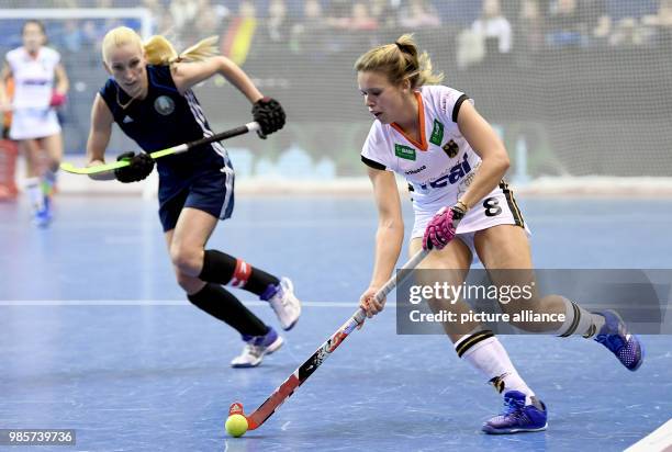 Anne Schroeder of Germany in action against Ryta Batura of Belarus during the women's Indoor Hockey World Cup 2018 semifinals match between Germany...