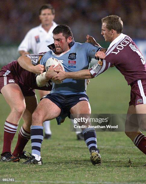 Darren Lockyer and Bradley Meyers of the Maroons tackle Robbie Kearns of the Blues during the first State of Origin match between NSW v QLD at...