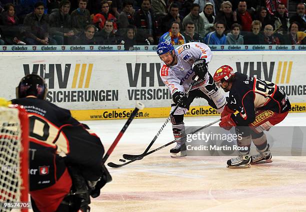 Andre Reiss of Hannover and Connor James of Augsburg battle for the puck during the DEL play off final match between Hannover Scorpions and...