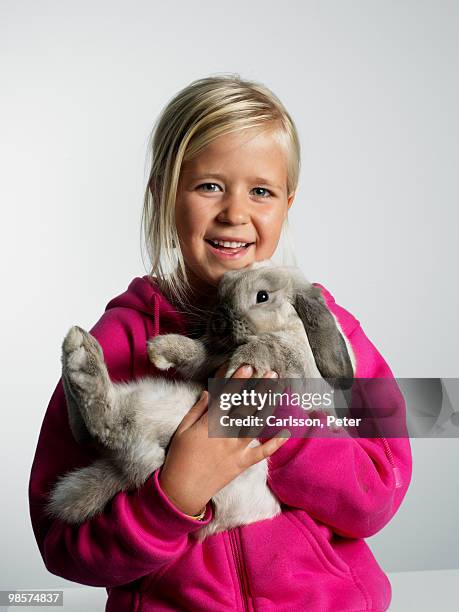 portrait of a girl with a rabbit in her arms. - cerise stockfoto's en -beelden