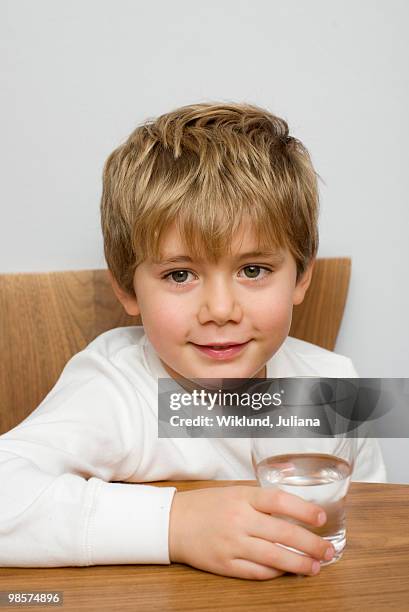 boy with a glass of water, sweden. - juliana posada - fotografias e filmes do acervo