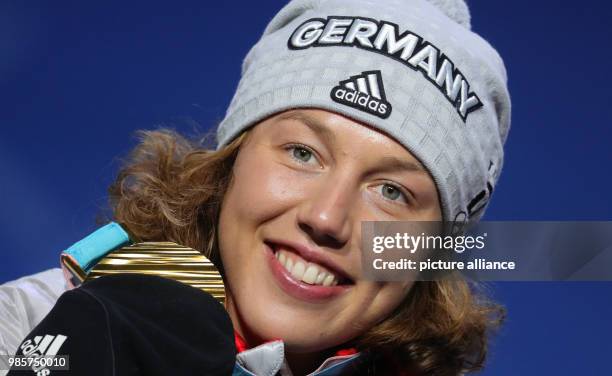 Dpatop - German gold medallist Laura Dahlmeier celebrates with her medal on the podium after winning the Women's Biathlon 7.5 km Sprint, during the...