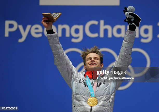 Dpatop - German gold medallist ski jumper Andreas Wellinger celebrates on the podium, after winning the men's normal hill individual ski jumping...