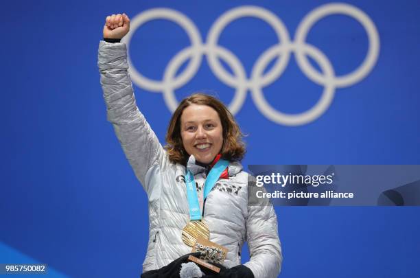 German gold medallist Laura Dahlmeier celebrates with her medal on the podium after winning the Women's Biathlon 7.5 km Sprint, during the medal...