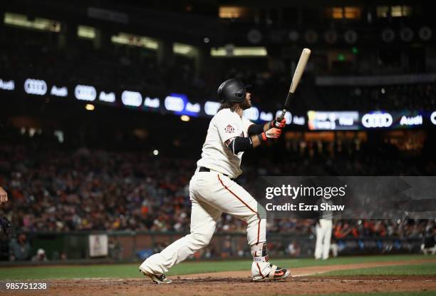 Brandon Crawford of the San Francisco Giants hits a walk off home run in the ninth inning to beat the Colorado Rockies at AT&T Park on June 27, 2018...