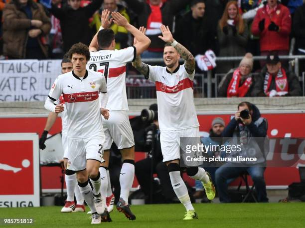 Stuttgart's Benjamin Pavard , Mario Gomez and goal scorer Daniel Ginczek celebrate the 1-0 goal during the German Bundesliga soccer match between VfB...