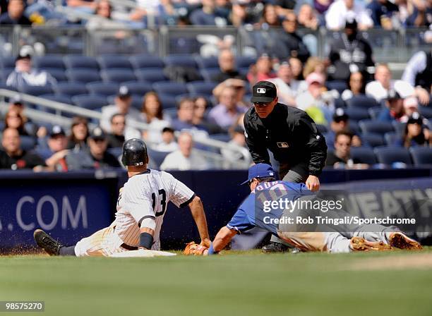 Alex Rodriguez of the New York Yankees seals third base as Michael Young of the Texas Rangers attempts to make the tag at Yankee Stadium on April 18,...