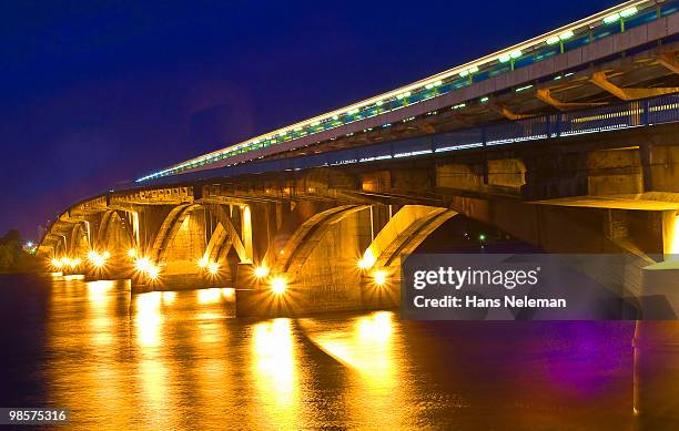 evening bridge of 'metro' across the river dnepr. - dnieper river stock pictures, royalty-free photos & images