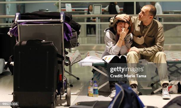 Stranded passengers Mercedes and Jimmy Elahcene from France hug inside John F. Kennedy International Airport where they have been stranded since...