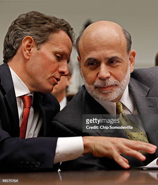 Treasury Secretary Timothy Geithner talks with Federal Reserve Bank Chairman Ben Bernanke while testifying before the House Financial Services...