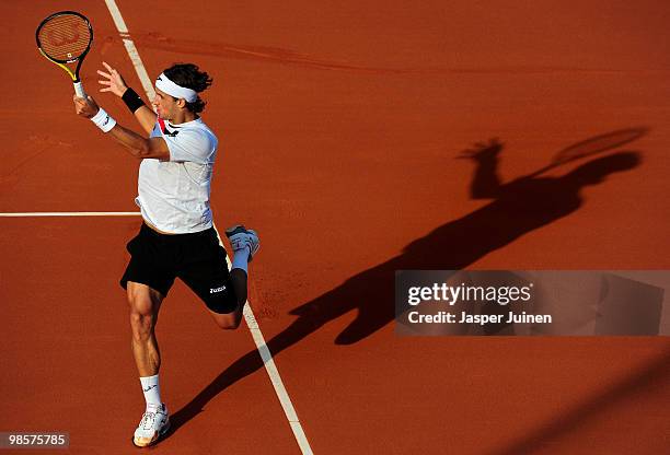 Feliciano Lopez of Spain casts his shadow on court as he follows the ball to Oleksandr Dolgopolov of the Ukrian on day two of the ATP 500 World Tour...