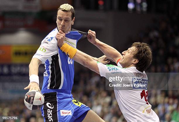 Pascal Hens of Hamburg is attacked by Fabian van Olphen of Magdeburg during the Toyota Handball Bundesliga match between SC Magdeburg and HSV Hamburg...