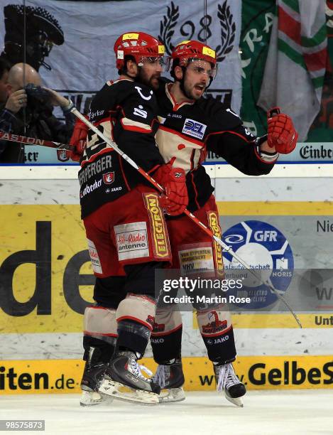 Matt Dzieduszycki of Hannover celebrates after he scores his team's opening goal during the DEL play off final match between Hannover Scorpions and...