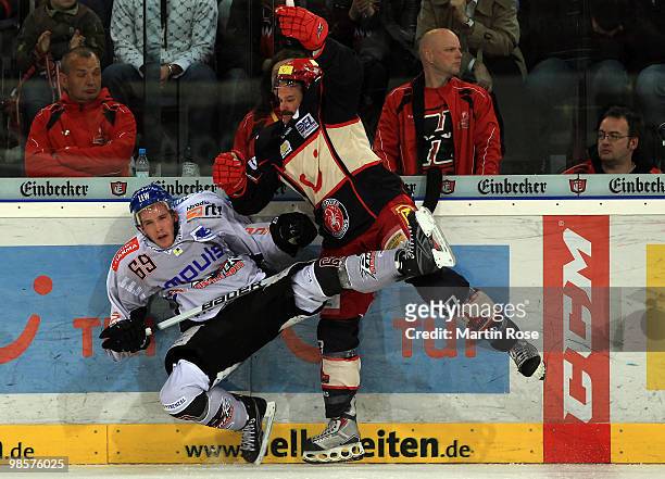 Tino Boos of Hannover tackles Florian Kettemer of Augsburg during the DEL play off final match between Hannover Scorpions and Augsburger Panther at...