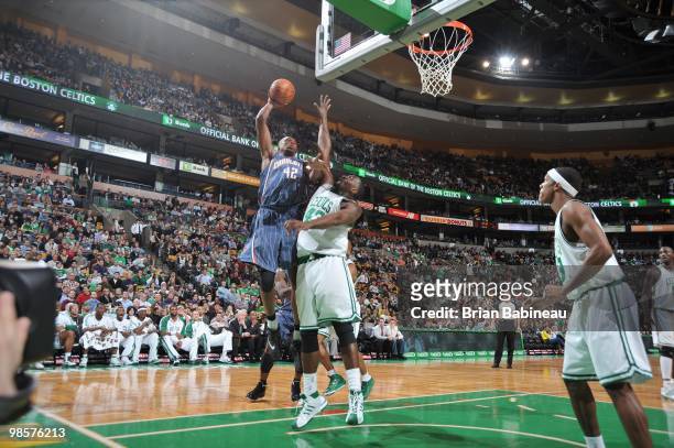Theo Ratliff of the Charlotte Bobcats takes a shot against Kendrick Perkins of the Boston Celtics on March 3, 2010 at the TD Garden in Boston,...