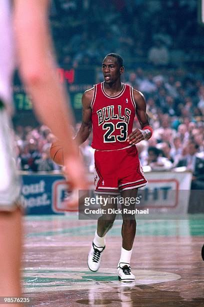 Michael Jordan of the Chicago Bulls moves the ball up court against the Boston Celtics during a game played in 1987 at the Boston Garden in Boston,...