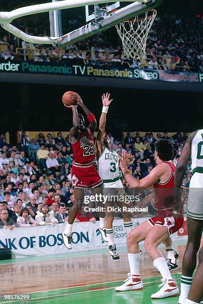 Michael Jordan of the Chicago Bulls shoots against Dennis Johnson of the Boston Celtics during a game played in 1987 at the Boston Garden in Boston,...