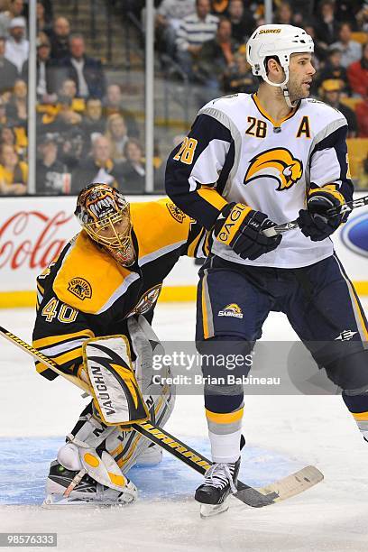 Tuukka Rask of the Boston Bruins tries to watch the play around Paul Gaustad of the Buffalo Sabers in Game Three of the Eastern Conference...