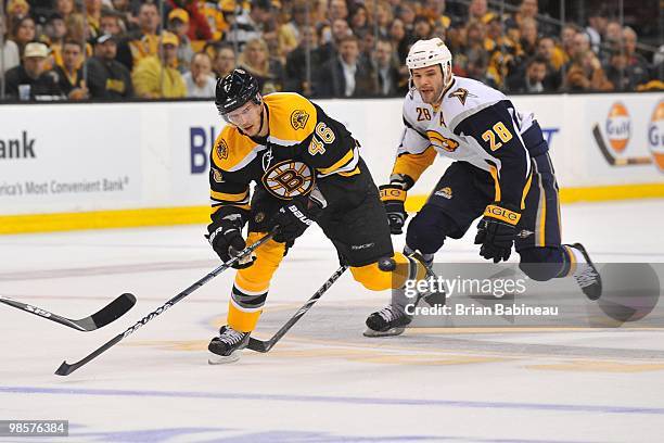 David Krejci of the Boston Bruins skates up the ice against Paul Gaustad of the Buffalo Sabers in Game Three of the Eastern Conference Quarterfinals...