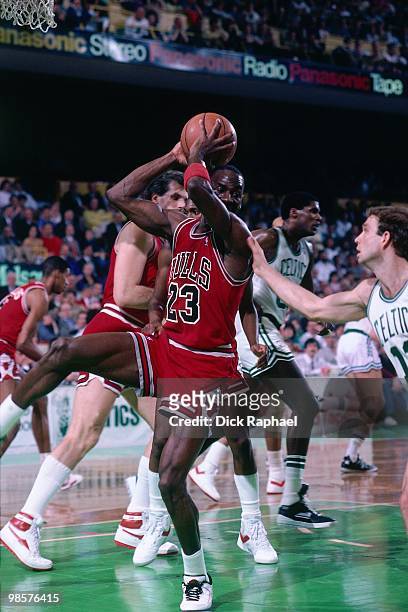 Michael Jordan of the Chicago Bulls rebounds against the Boston Celtics during a game played in 1987 at the Boston Garden in Boston, Massachusetts....