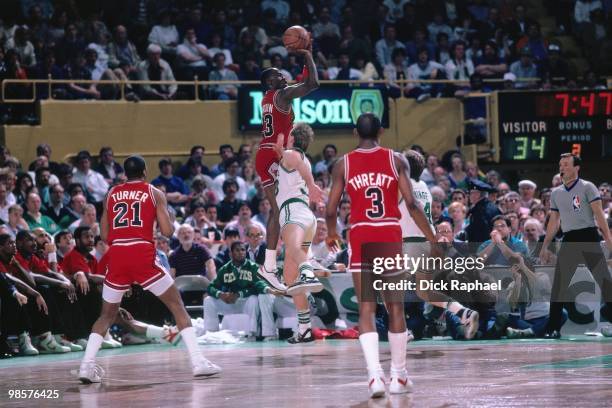 Michael Jordan of the Chicago Bulls shoots a jump shot against Larry Bird of the Boston Celtics during a game played in 1987 at the Boston Garden in...