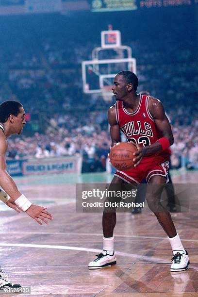 Michael Jordan of the Chicago Bulls looks to make a move against the Boston Celtics during a game played in 1987 at the Boston Garden in Boston,...