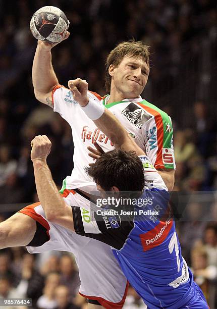 Fabian van Olphen of Magdeburg is attacked by Matthias Flohr of Hamburg during the Toyota Handball Bundesliga match between SC Magdeburg and HSV...