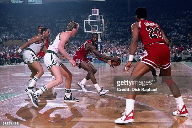 Michael Jordan of the Chicago Bulls passes against the Boston Celtics during a game played in 1987 at the Boston Garden in Boston, Massachusetts....