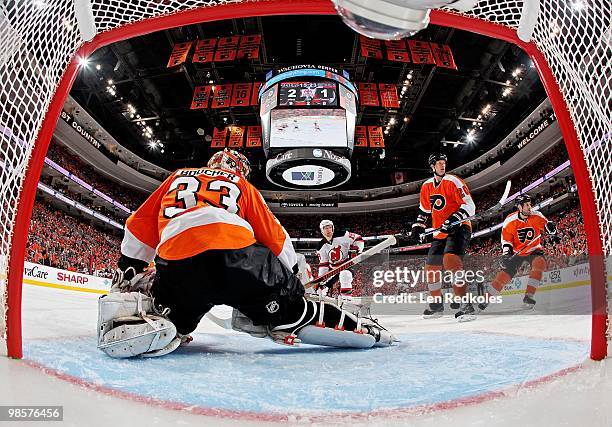 Travis Zajac of the New Jersey Devils shoots the puck wide of the net against Brian Boucher, Chris Pronger and Ian Laperriere of the Philadelphia...