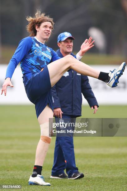Ben Brown of the Kangaroos kicks the ball during a North Melbourne Kangaroos AFL training session at Arden Street Ground on June 28, 2018 in...