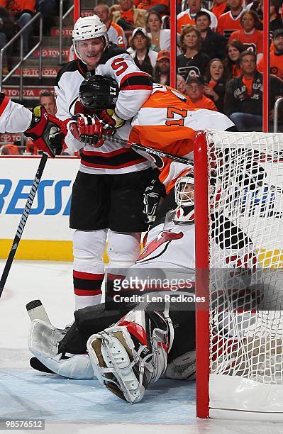 Colin White of the New Jersey Devils with teammate Martin Brodeur watches him place Jeff Carter of the Philadelphia Flyers in a headlock in Game...