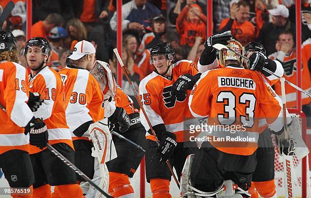 Mike Richards, Johan Backlund, Matt Carle and Brian Boucher of the Philadelphia Flyers celebrate Carcillo's game-winning goal against the New Jersey...