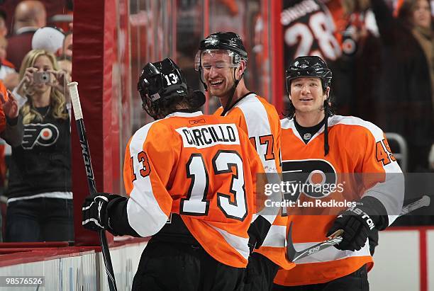 Dan Carcillo, Jeff Carter and Arron Asham of the Philadelphia Flyers celebrate Carcillo's game-winning goal against the New Jersey Devils in overtime...