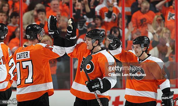 Jeff Carter, Matt Carle and Danny Briere of the Philadelphia Flyers celebrate Carcillo's game-winning goal against the New Jersey Devils in overtime...