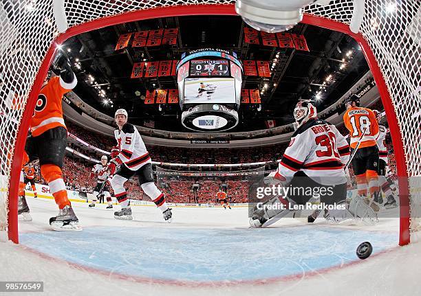 Colin White and Martin Brodeur of the New Jersey Devils both could not stop a first period goal by Claude Giroux of the Philadelphia Flyers in Game...